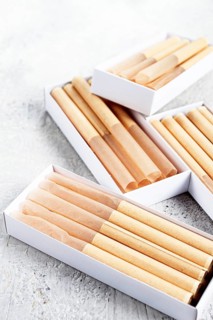 Cigarette casings, packed in boxes, on the table, top view
