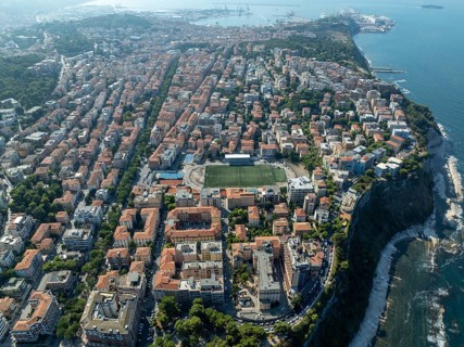 A stunning aerial view of Ancona, showcasing its vibrant architecture, coastline, and lush greenery
