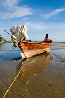 Longtail boat on the shores of Nai Yang Beach in the north of the Thai holiday island Phuket,