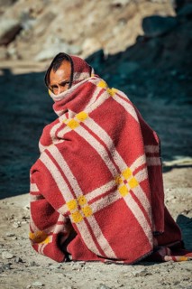 SARCHU, INDIA, SEPTEMBER 2, 2011: Indian man muffled in blanket on cold morning on Manali-Leh road