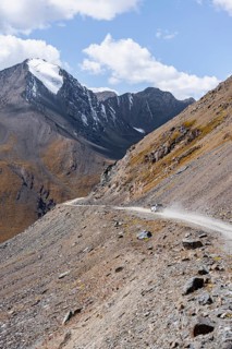 Narrow gravel track in mountain landscape at Chong Ashuu Pass, Tian Shan Mountains, Issyk-Kul,