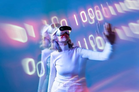 An elderly Asian woman immersed in the metaverse, wearing virtual reality goggles. She interacts