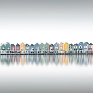 A series of colorful modern and colorful waterfront houses in a family-friendly suburban