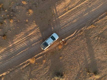 Top down view, off-road car on dust road, aerial view, Erongo, Damaraland, Namibia