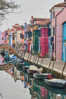 Colorful houses beside the waterway at 'Fondamenta di Terranova' with boats lying in the water on