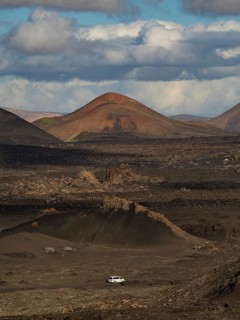 Dramatic volcanic landscape and vast skies of Timanfaya National Park in Lanzarote, showcasing