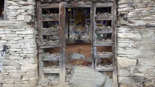 Buddhist stone shrine with religious motif, trekking at Annapurna Circuit, Manang, Nepal