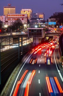 Motorway A40, Ruhr expressway, heavy traffic jam, rush hour, city passage in Essen, skyline of the
