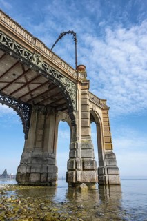 The historic castle pier built in 1879 on the banks of Friedrichshafen at low tide, tourist