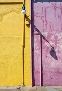 Purple and yellow house facade with street lamp, colourful houses on the island of Burano, Venice,