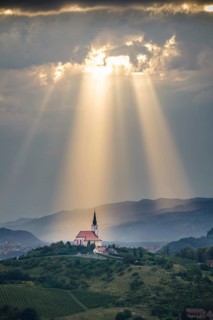 Sun rays shining down on a Church in Slovenia