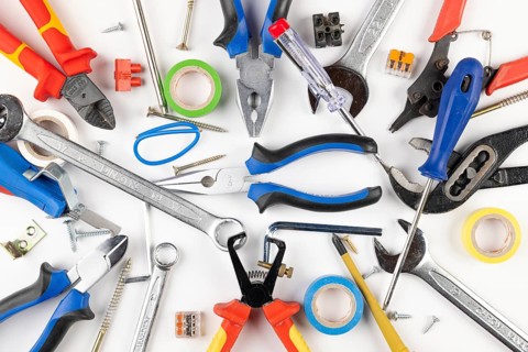 Various tools and materials scattered on white background