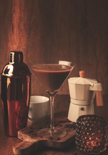Espresso martini cocktail, alcoholic drink, shaker and geyser coffee maker, on a wooden background