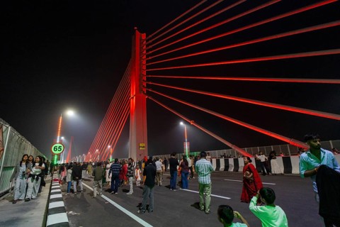 People gather on the newly inaugurated Kumar Bhaskar Varma Setu, a six-lane cable styled bridge