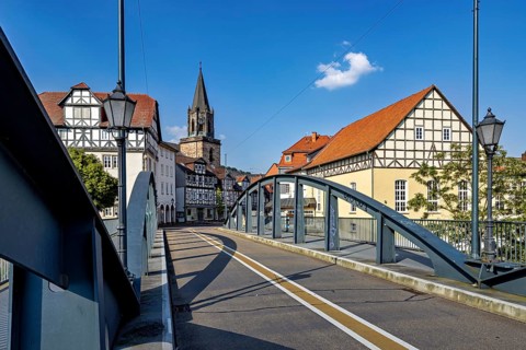 Town view with bridge, half-timbered houses and church in fine weather, The town of Rotenburg an