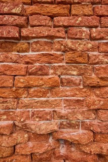Detail of an old ziggurat wall made of bakestone bricks, Venice Italy