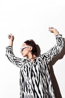 A fashion model exudes confidence wearing an eye-catching zebra animal print top. Captured using