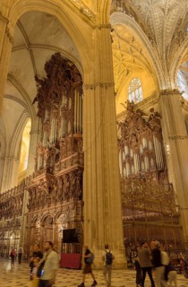 Large organ with rich wood carvings in a Gothic church, Seville, Andalusia, Spain