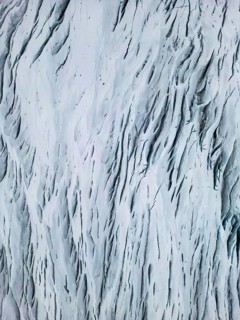 Aerial view of the Icelandic winter landscape, capturing the intricate patterns of snow-covered