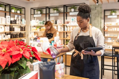 Employees organize and manage a variety of beauty products in a vibrant cosmetics store.