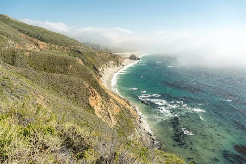 Big Sur's stunning coastline, where rugged cliffs and lush flora create a dramatic encounter with