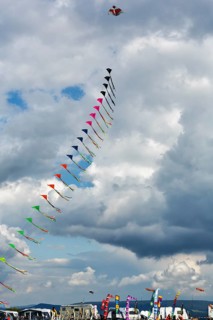 Colourful, strung kites flying in the sky, garland, kite festival in Vinsebeck, mobile homes,