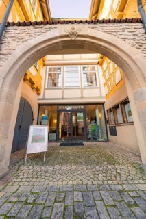Entrance to a museum through a stone archway in the historic city centre, Sindelfingen, Böblingen