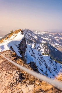 View of a snowy mountain peak with hiking trail in sunlight, Hochgrat Mountains, Allgäu Alps,