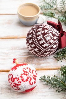 Christmas or New Year composition. Decorations, knitted balls, fir and spruce branches, cup of