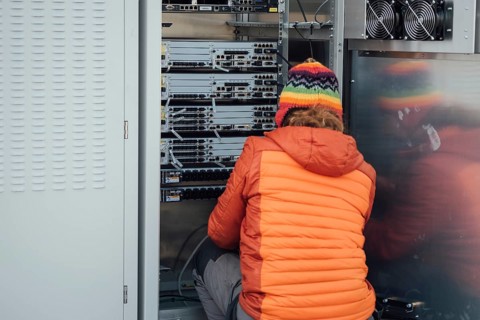 Fitter working in teletechnical cabinet