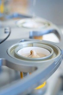Machine fills yoghurt precisely into a cup, ice cream production Haselstaller Hof, Calw district,