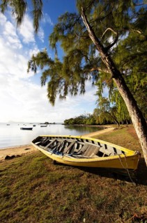 Yellow fishing boat on the beach at Calodyne, Riviere du Rempart district, Mauritius