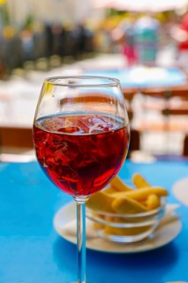 Drink, aperitif, aperol soda with ice cream, pastries in the back, lifestyle, enjoyment, osteria,