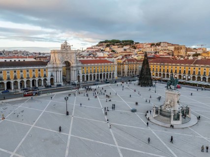 Beautiful winter sunset over Praca do Comercio featuring the Arco da Rua Augusta and a decorated