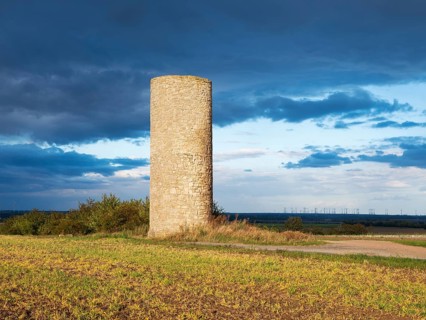 The Hakeborner Warte in a field in autumn, medieval watchtower in the Magdeburger Börde, blue sky