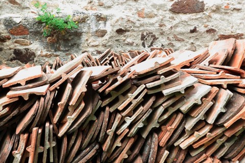Old roof tiles stored on stockpiles for reuse on historic buildings and heritage-protected houses,
