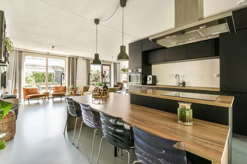 Stylish modern kitchen featuring sleek cabinetry, open space, and ample natural light. Perfect