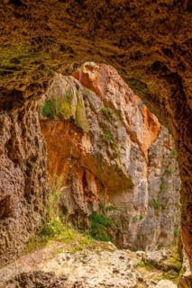 Natural window inside the Iris Grotto at the Cola de Caballo Waterfall in the Monasterio de Piedra
