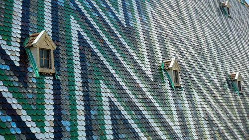 Colourful tiled roof with small windows and geometric pattern, Vienna