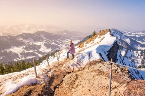 Person on a snowy trail with views of mountains, Hochgrat Mountains, Allgäu Alps, Oberreute,
