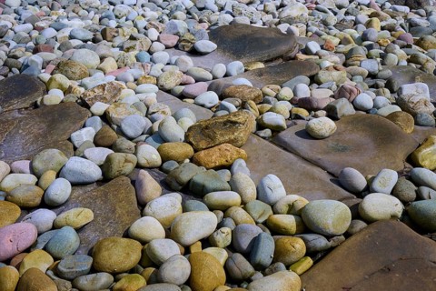 A variety of colorful pebbles on a beach, some irregularly shaped and arranged, Elgol Beach, Elgol,