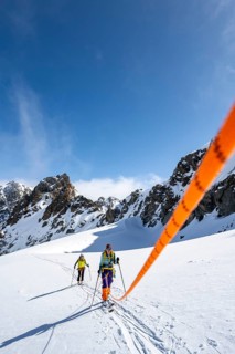 Ski tourer with rope, rope team on the Vadret da Porchabella glacier on the ascent to the summit of