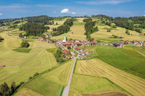Aerial view over fields and meadows to village Vorderburg, agricultural area in spring, Allgäu,