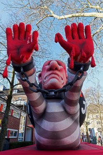 President Putin as a convict with blood on his hands, Put In Jail, papier-mâché figure, theme float