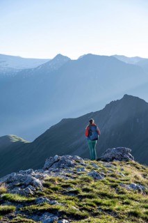 Hiker enjoying the mountain panorama in the morning, Venediger group, behind Dreiherrenkopf,