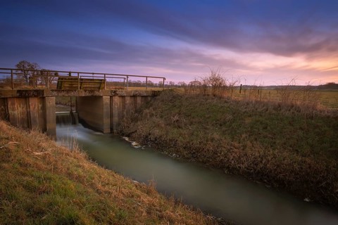 View of a sluice and a bridge with a pasture behind it at sunset, Kirchlinteln, Verden, Aller Leine