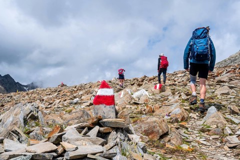 Red and white trail markings, hiker in the high mountains, Lasörling High Trail, Lasörling High