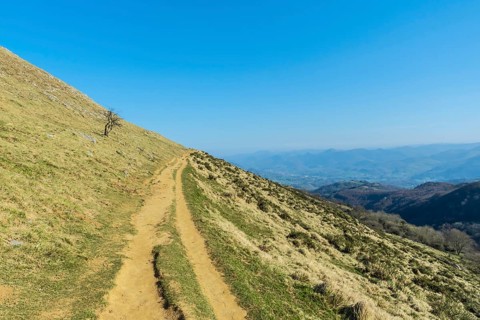 Descent trail from the summit to Mount Ernio or Hernio in Gipuzkoa at sunset, Basque Country