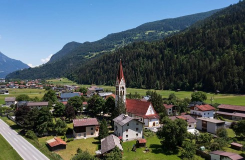 Drone shot, view of village with parish church, Schönwies, Oberinntal, Tyrol, Austria