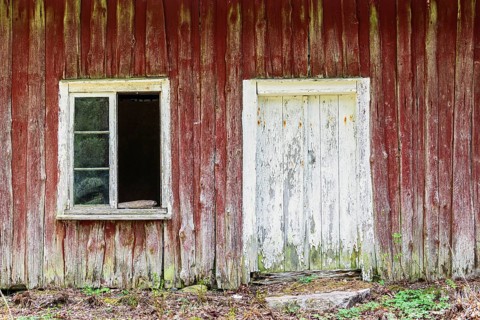 Old dilapidated abandoned wooden house with a broken window, Sweden